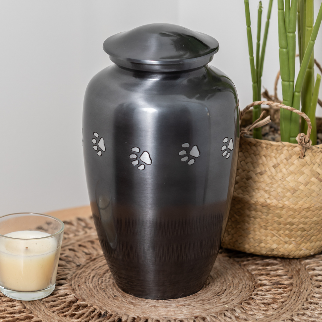Classic style silver urn with etched pawprints in natural setting